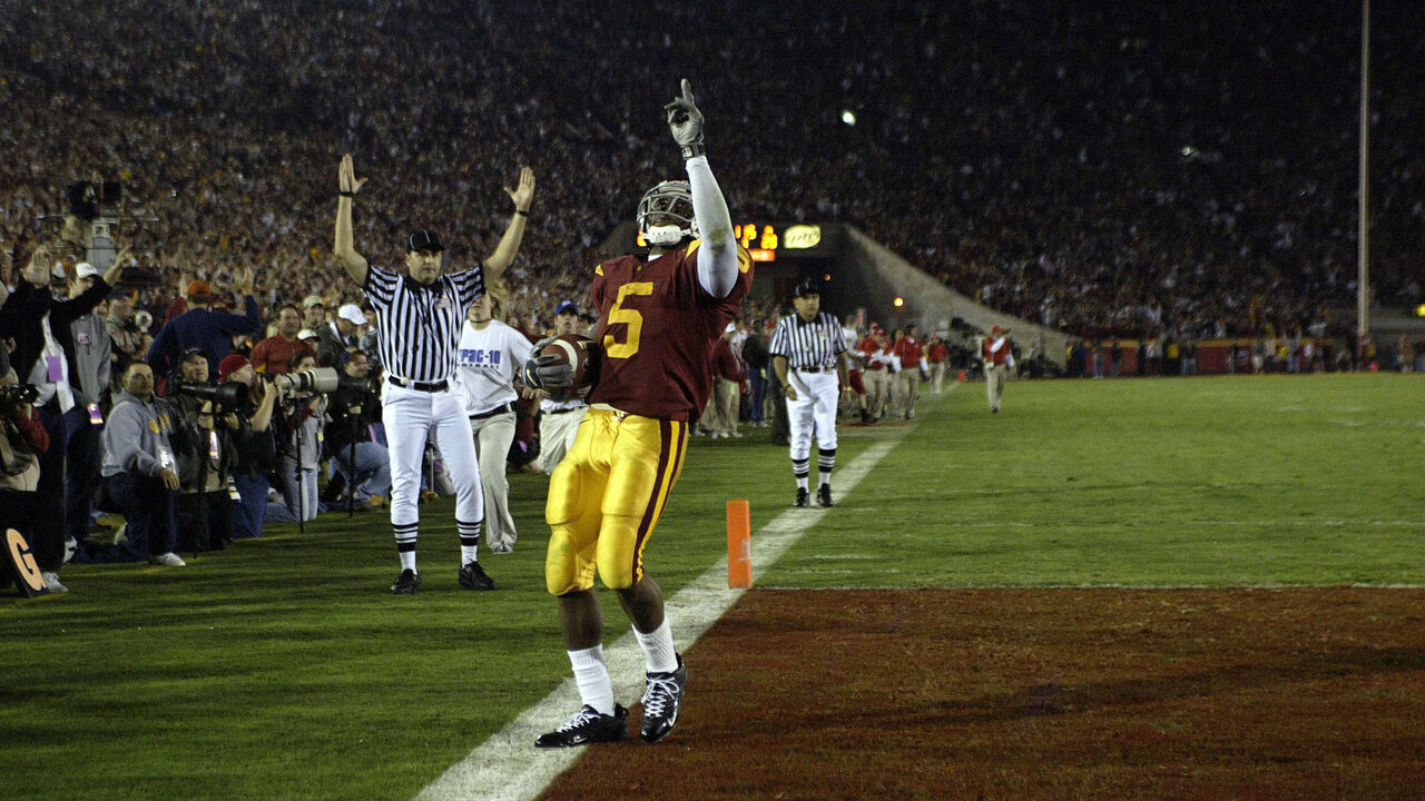 Reggie Bush of USC reacts to scoring a touchdown against the Fresno State Bulldogs at Memorial Coliseum in Los Angeles, CA. USC defeated Fresno State 50-42 to extend their winning streak to 33 games.