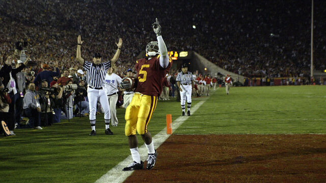 Reggie Bush of USC reacts to scoring a touchdown against the Fresno State Bulldogs at Memorial Coliseum in Los Angeles, CA. USC defeated Fresno State 50-42 to extend their winning streak to 33 games.