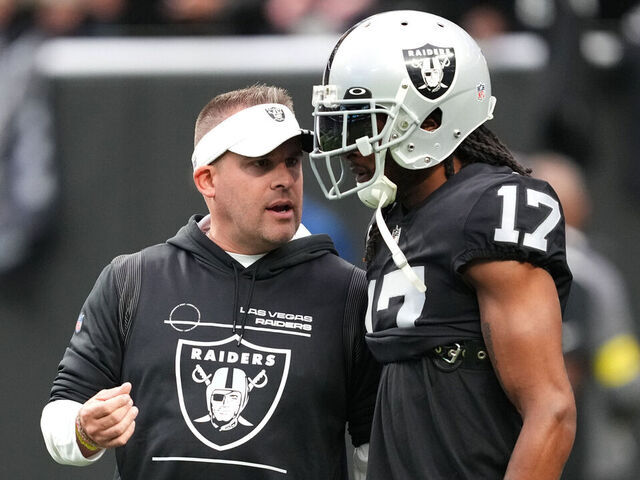 LAS VEGAS, NEVADA - DECEMBER 04: Head coach Josh McDaniels speaks to wide receiver Davante Adams #17 of the Las Vegas Raiders before a game against the Los Angeles Chargers at Allegiant Stadium on December 04, 2022 in Las Vegas, Nevada.