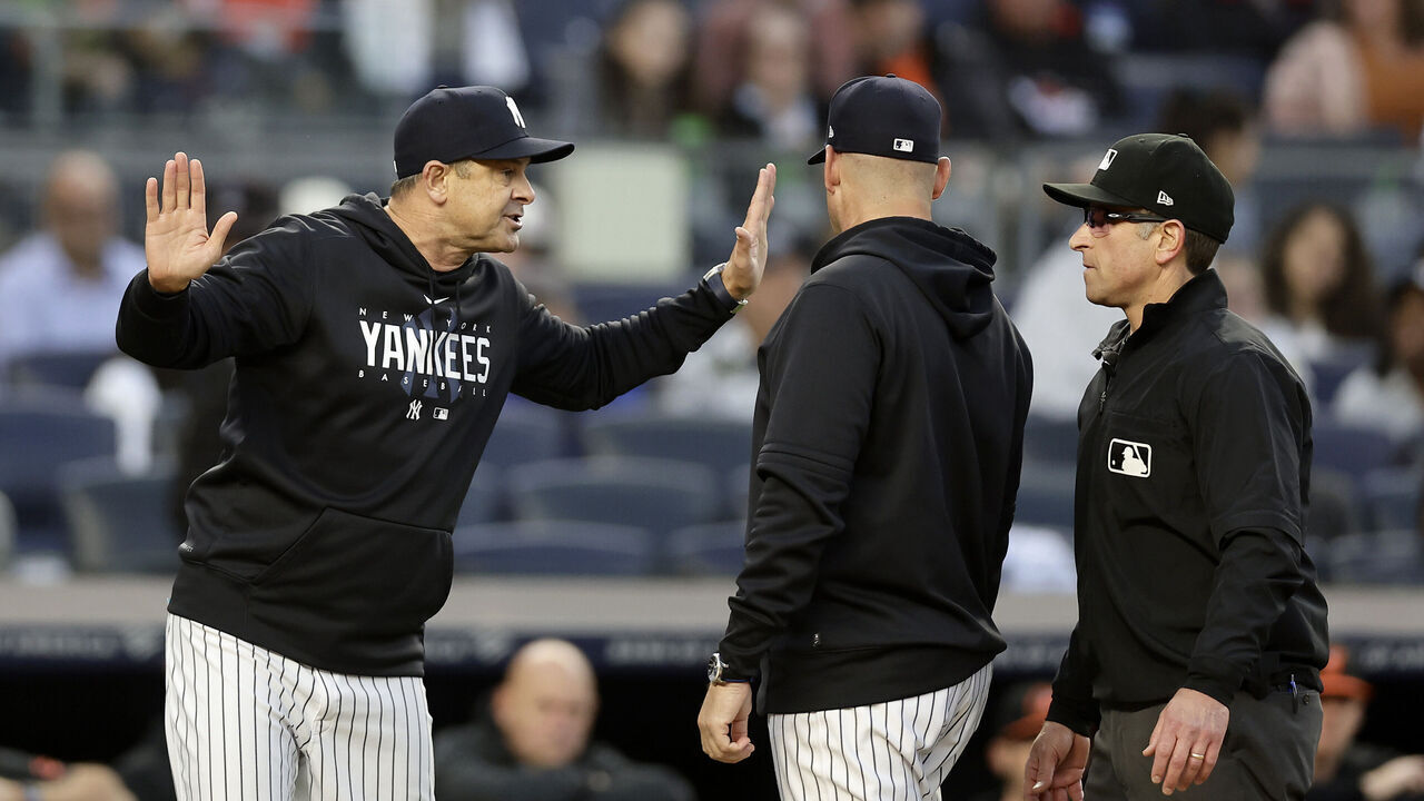 BRONX, NEW YORK - MAY 25: Manager Aaron Boone #17 of the New York Yankees argues with first base umpire Chris Guccione after he was ejected from a game against the Baltimore Orioles in the third inning at Yankee Stadium on May 25, 2023 in Bronx, New York.