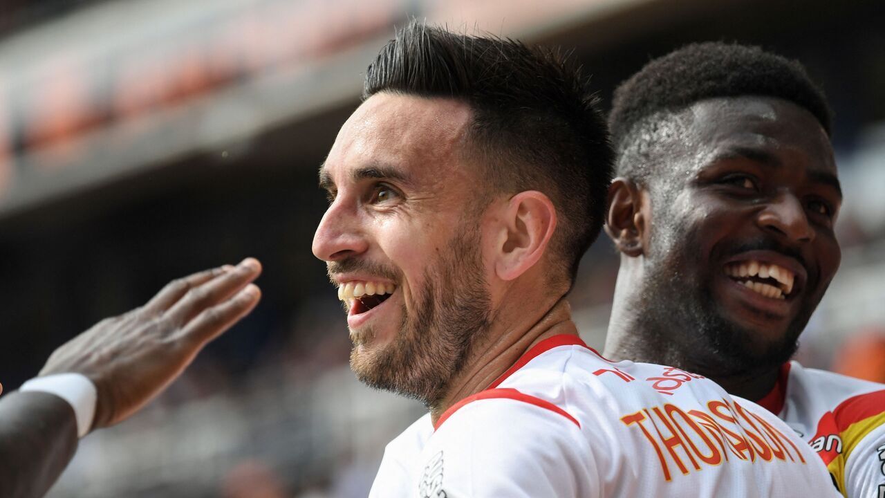 Lens' French forward Adrien Thomasson (C) celebrates after scoring his team's second goal during the French L1 football match between FC Lorient and RC Lens at Stade du Moustoir in Lorient, western France on May 21, 2023.