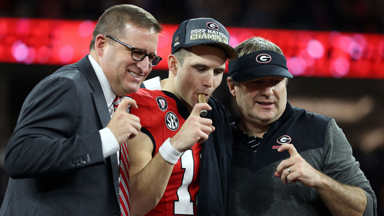 INGLEWOOD, CALIFORNIA - JANUARY 09: Director of Athletics Josh Brooks, head coach Kirby Smart and Stetson Bennett #13 of the Georgia Bulldogs celebrate after defeating the TCU Horned Frogs in the College Football Playoff National Championship game at SoFi Stadium on January 09, 2023 in Inglewood, California. Georgia defeated TCU 65-7.