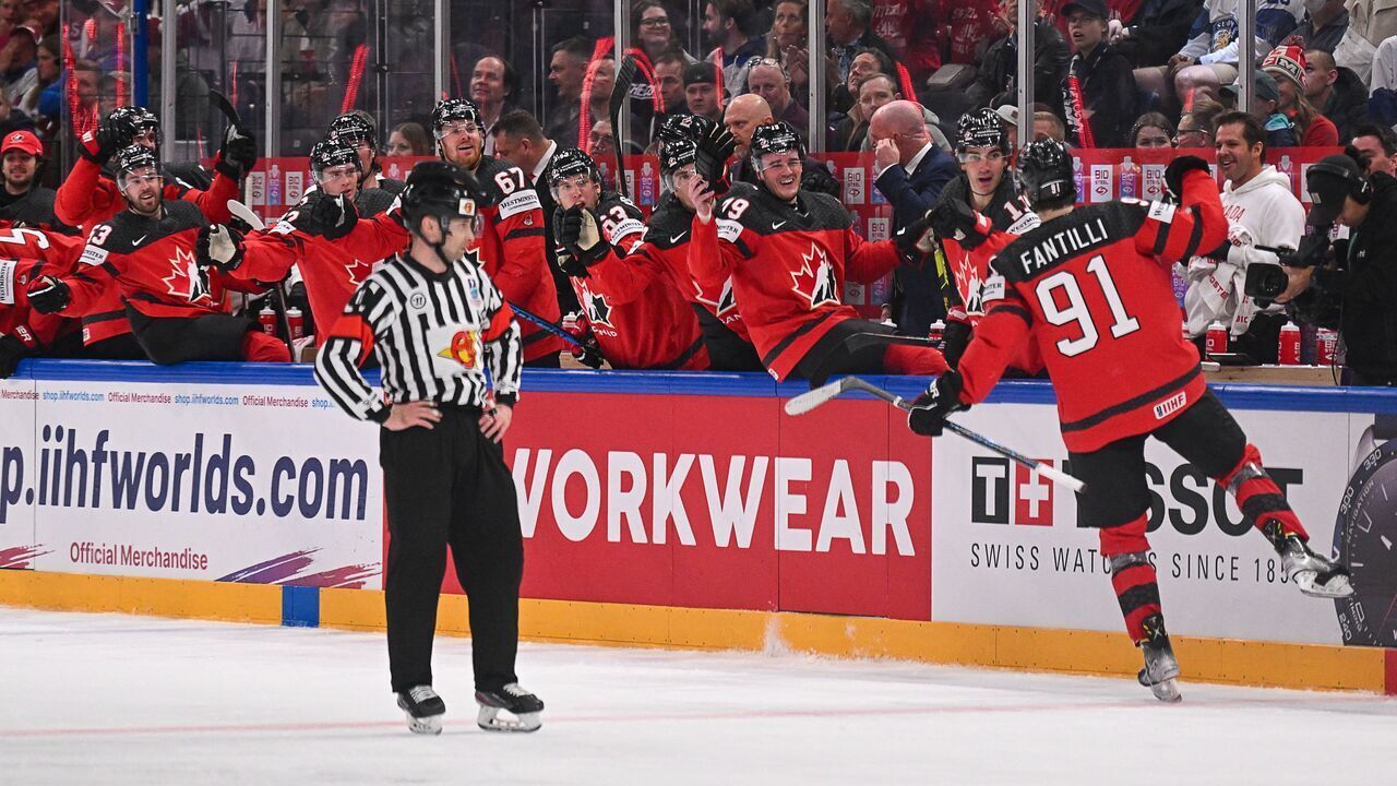 Canada's forward Adam Fantilli (R) celebrates scoring his team's thrid goal during the IIHF Ice Hockey Men's World Championship semi-final match between Canada and Latvia in Tampere, Finland on May 27, 2023.
