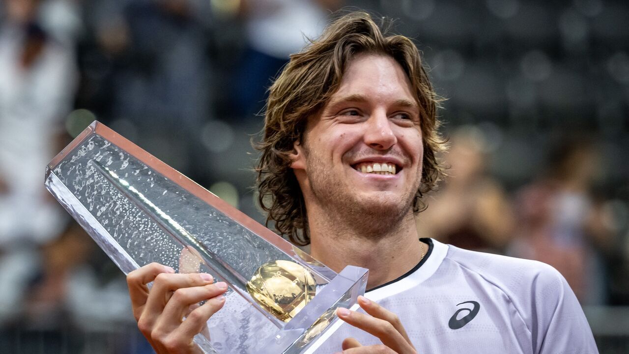 Chile's Nicolas Jarry raises the trophy after winning his final match against Bulgaria's Grigor Dimitrov during their final match at the ATP 250 Geneva Open tennis tournament in Geneva on May 27, 2023.