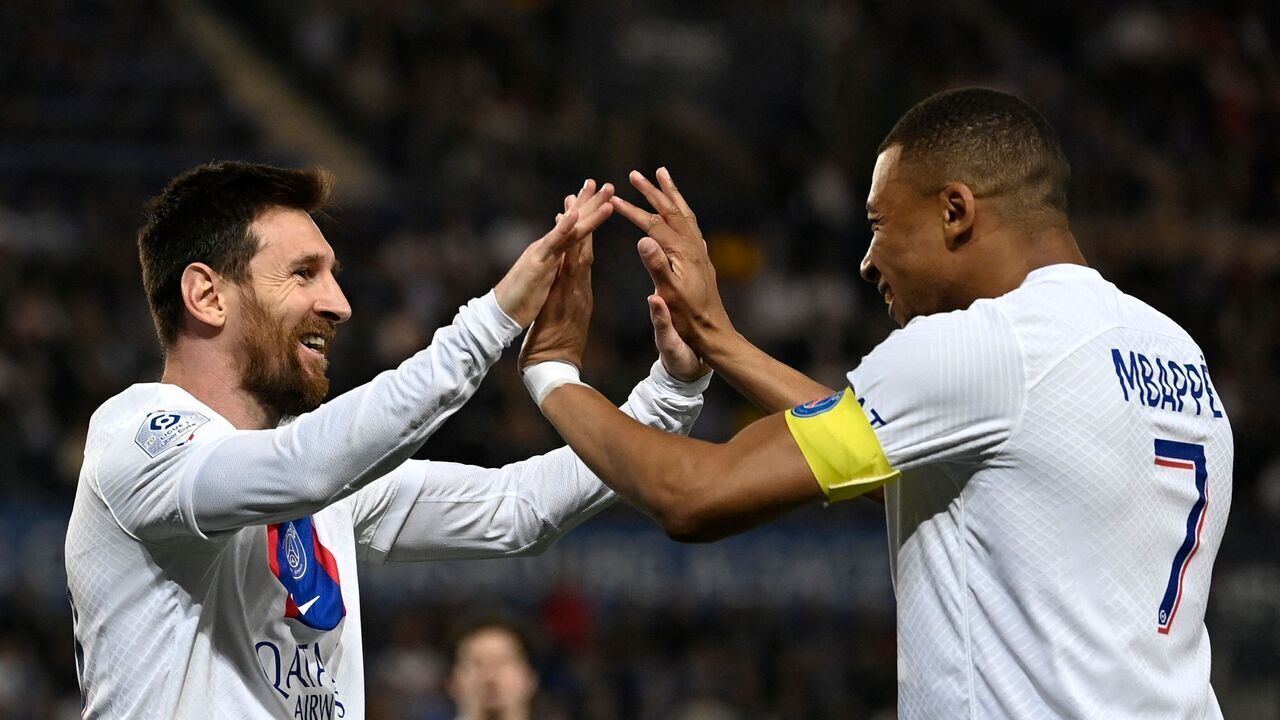 Paris Saint-Germain's Argentine forward Lionel Messi celebrates with Paris Saint-Germain's French forward Kylian Mbappe after scoring his team's first goal during the French L1 football match between RC Strasbourg Alsace and Paris Saint-Germain (PSG) at Stade de la Meinau in Strasbourg, eastern France on May 27, 2023.