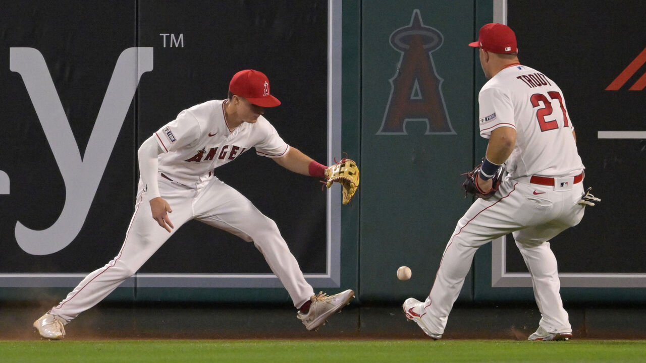 ANAHEIM, CALIFORNIA - MAY 27: Mickey Moniak #16 and Mike Trout #27 of the Los Angeles Angels scramble to field a two RBI double hit by Garrett Cooper #26 of the Miami Marlins in the tenth inning at Angel Stadium of Anaheim on May 27, 2023 in Anaheim, California.