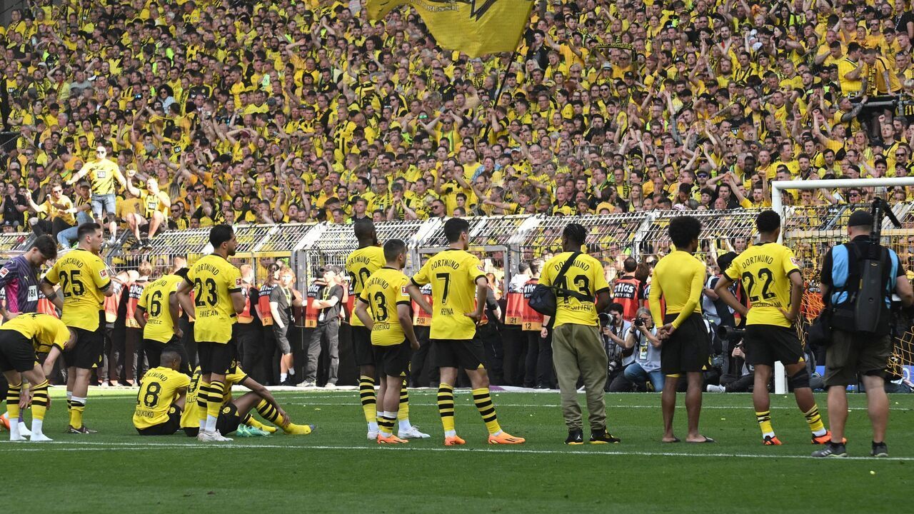 TOPSHOT - Dortmund players go to their fans after the German first division Bundesliga football match between Borussia Dortmund and 1 FSV Mainz 05 in Dortmund, western Germany on May 27, 2023.
