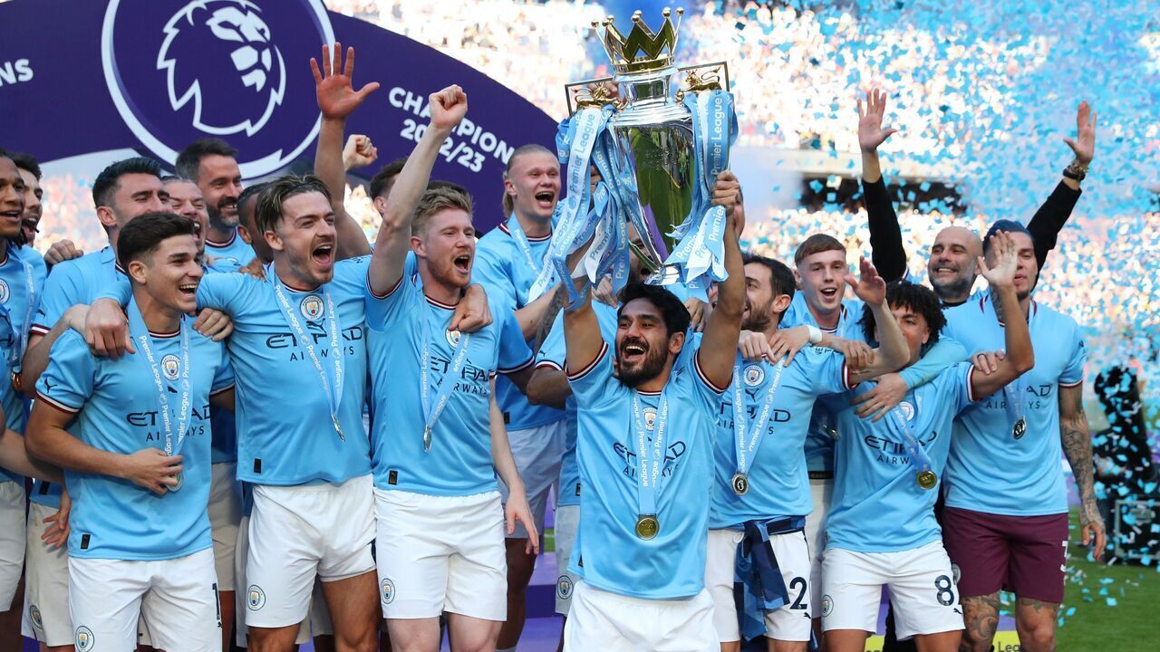 Manchester City's players celebrate with the Premier League trophy after the English Premier League football match between Manchester City and Chelsea in Manchester, Britain, May 21, 2023. Manchester City were confirmed as the 2022-2023 Premier League champions on Saturday without having to kick a ball as Arsenal were beaten 1-0 away to Nottingham Forest.