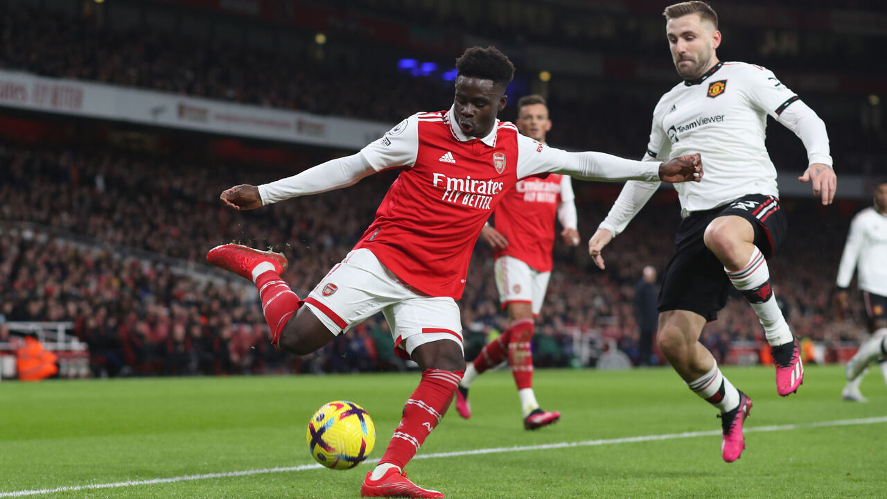 LONDON, ENGLAND - JANUARY 22: Bukayo Saka of Arsenal and Luke Shaw of Manchester United during the Premier League match between Arsenal FC and Manchester United at Emirates Stadium on January 22, 2023 in London, United Kingdom.