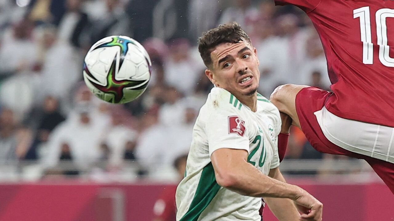 Algeria's defender Ilyes Chetti (L) vies for the ball with Qatar's midfielder Hassan al-Haydos (C) during the FIFA Arab Cup 2021 semi-final football match between Qatar and Algeria at the Al-Thumama stadium in the Qatari capital of Doha on December 15, 2021.
