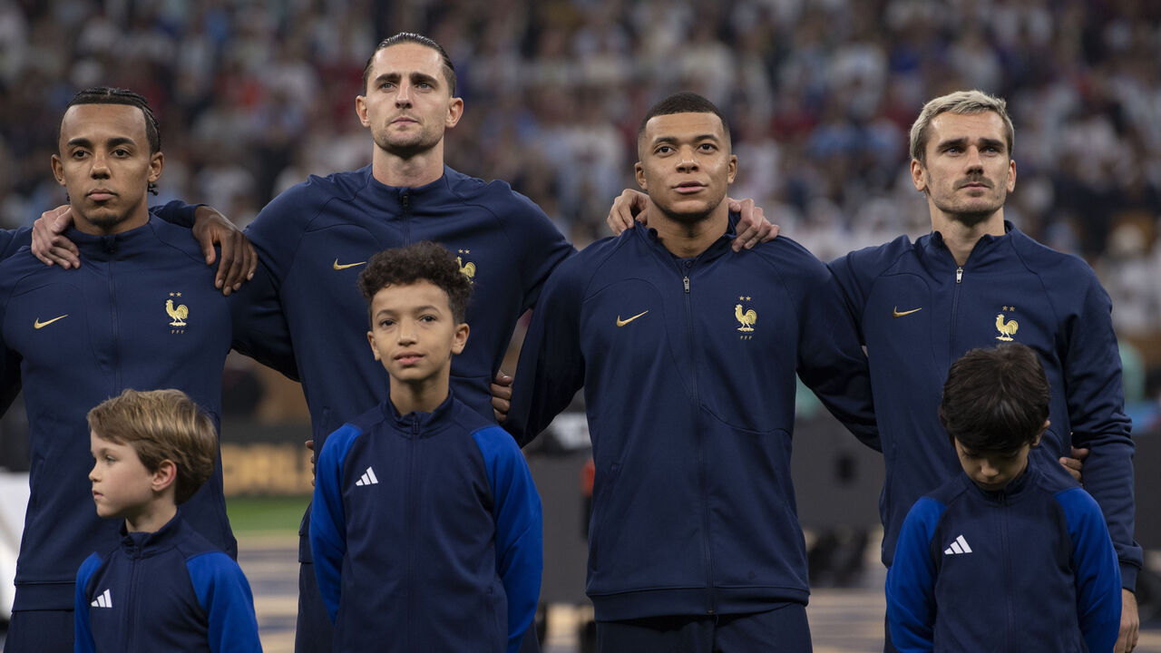 LUSAIL CITY, QATAR - DECEMBER 18: Jules Kounde, Adrien Rabiot, Kylian Mbappe and Antoine Griezmann of France line up for the national anthems with mascots ahead of the FIFA World Cup Qatar 2022 Final match between Argentina and France at Lusail Stadium on December 18, 2022 in Lusail City, Qatar.