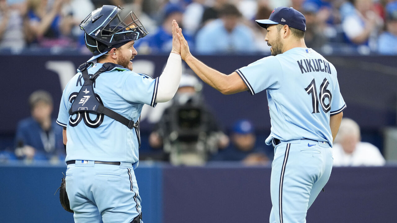 TORONTO, ON - MAY 30: Yusei Kikuchi #16 of the Toronto Blue Jays celebrates with Alejandro Kirk #30 after the fourth inning where he recorded his 500th career strikeout against the Milwaukee Brewers in their MLB game at the Rogers Centre on May 30, 2023 in Toronto, Ontario, Canada.