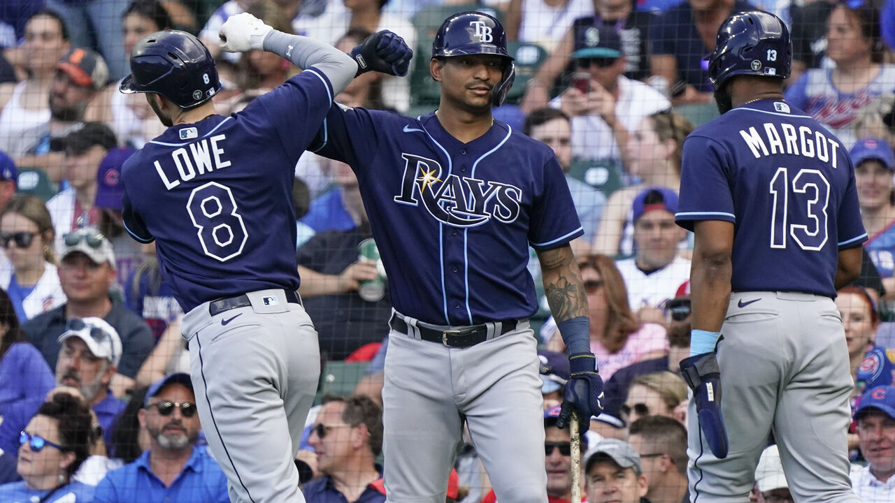 CHICAGO, ILLINOIS - MAY 31: Brandon Lowe #8 of the Tampa Bay Rays is congratulated by Christian Bethancourt #14 of the Tampa Bay Rays following a two-run during the seventh inning of a game against the Chicago Cubs at Wrigley Field on May 31, 2023 in Chicago, Illinois.