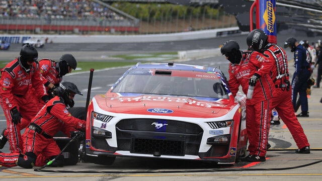 CHARLOTTE, NC - MAY 29: The pit crew of Chase Briscoe (#14 Stewart Haas Racing Mahindra Tractors Ford) prepares to service the car during the running of the 64th annual NASCAR Cup Series Coca-Cola 600 on May 29, 2023 at Charlotte Motor Speedway in Charlotte, NC.