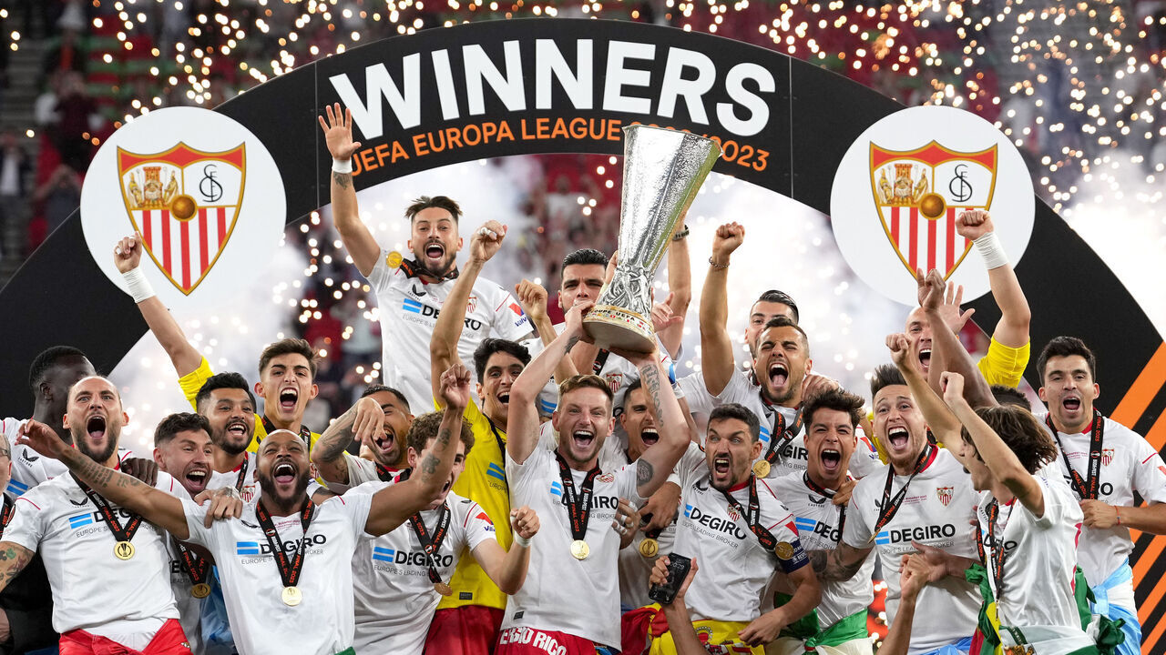 BUDAPEST, HUNGARY - MAY 31: Ivan Rakitic of Sevilla FC lifts the UEFA Europa League trophy after the team's victory during the UEFA Europa League 2022/23 final match between Sevilla FC and AS Roma at Puskas Arena on May 31, 2023 in Budapest, Hungary.