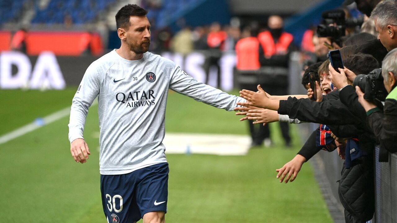 Paris Saint-Germain's Argentine forward Lionel Messi greets supporters during a warm up session prior to the French L1 football match between Paris Saint-Germain (PSG) and FC Lorient at The Parc des Princes Stadium in Paris on April 30, 2023.