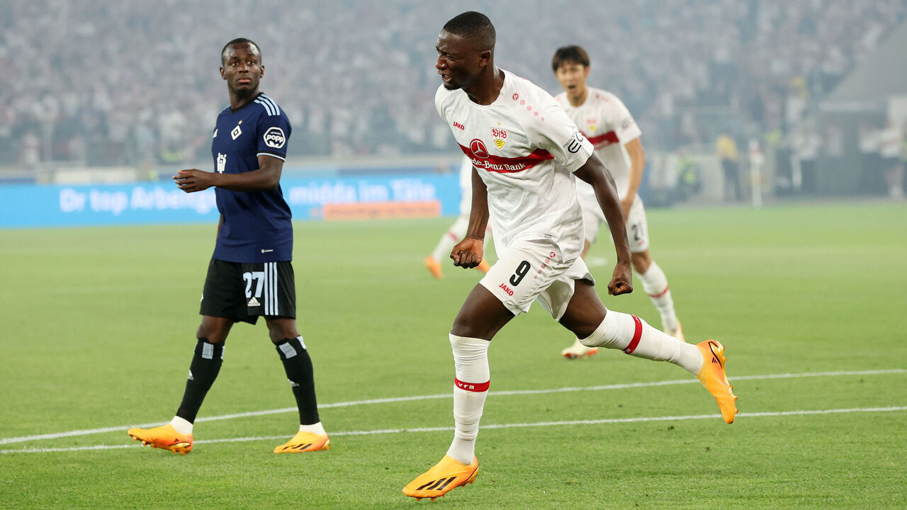 STUTTGART, GERMANY - JUNE 01: Sehrou Guirassy of VfB Stuttgart celebrates after scoring the team's third goal as Jean-Luc Dompe of Hamburger SV looks on during the Bundesliga playoffs first leg match between VfB Stuttgart and Hamburger SV at Mercedes-Benz Arena on June 01, 2023 in Stuttgart, Germany.