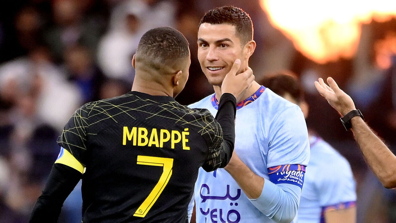 Paris Saint-Germain's French forward Kylian Mbappe (L) chats with Riyadh All-Star's Portuguese forward Cristiano Ronaldo (R) during the Riyadh Season Cup football match between the Riyadh All-Stars and Paris Saint-Germain at the King Fahd Stadium in Riyadh on January 19, 2023.
