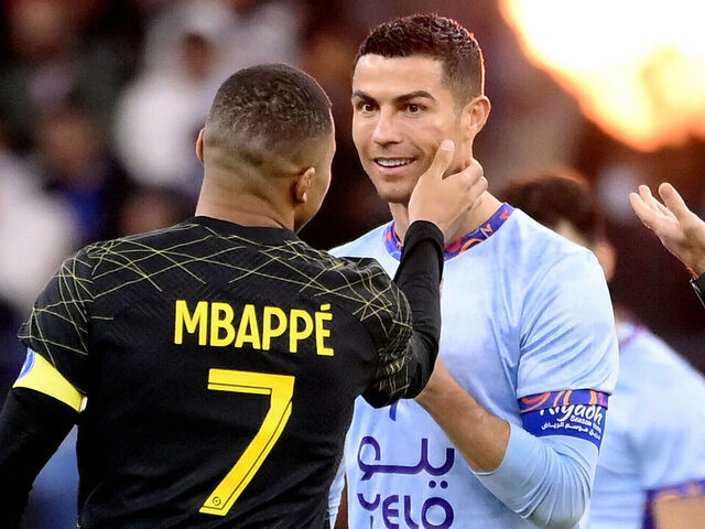 Paris Saint-Germain's French forward Kylian Mbappe (L) chats with Riyadh All-Star's Portuguese forward Cristiano Ronaldo (R) during the Riyadh Season Cup football match between the Riyadh All-Stars and Paris Saint-Germain at the King Fahd Stadium in Riyadh on January 19, 2023.