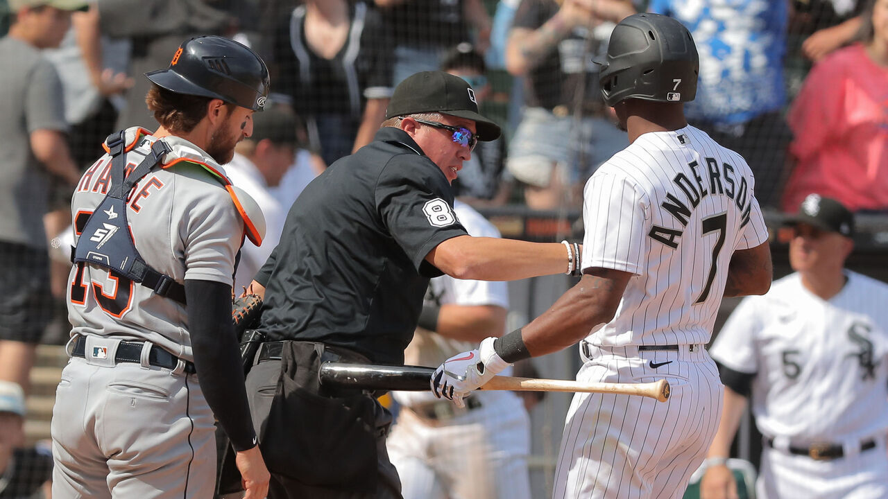 CHICAGO, IL - JUNE 03: Chicago White Sox shortstop Tim Anderson (7) helps umpire Cory Blaser (89) up after being hit on by a wild pitch that scored Chicago White Sox third baseman Yoan Moncada (10) during a Major League Baseball game between the Detroit Tigers and the Chicago White Sox on June 3, 2023 at Guaranteed Rate Field in Chicago, IL.
