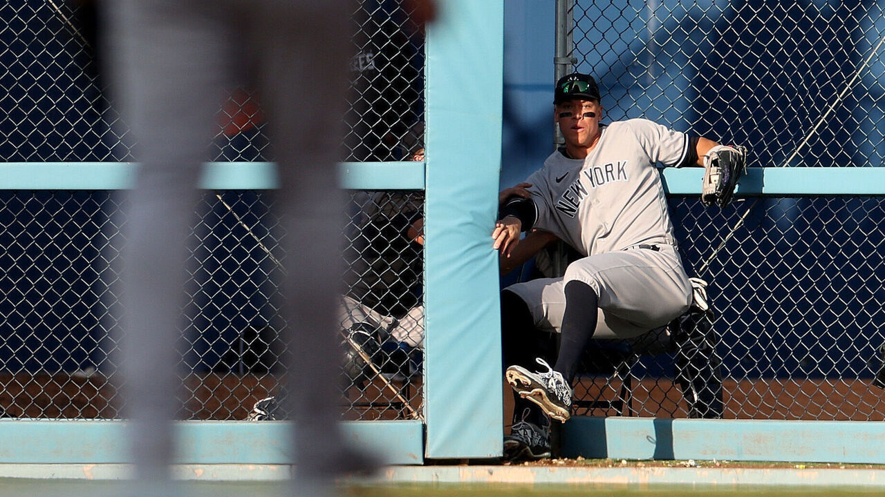LOS ANGELES, CALIFORNIA - JUNE 03: Aaron Judge #99 of the New York Yankees crashes through the outfield fence as he makes a catch for an out of J.D. Martinez #28 of the Los Angeles Dodgers during the eighth inning at Dodger Stadium on June 03, 2023 in Los Angeles, California.