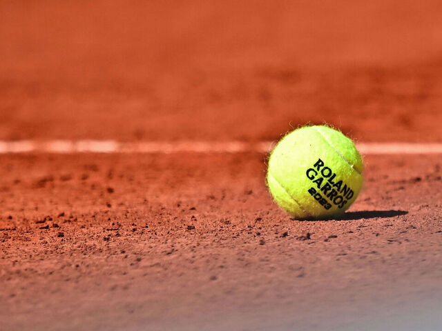 A Roland Garros 2023 official tennis ball sits on the court during a men's singles match on day seven of the Roland-Garros Open tennis tournament at the Court Simonne-Mathieu in Paris on June 3, 2023.