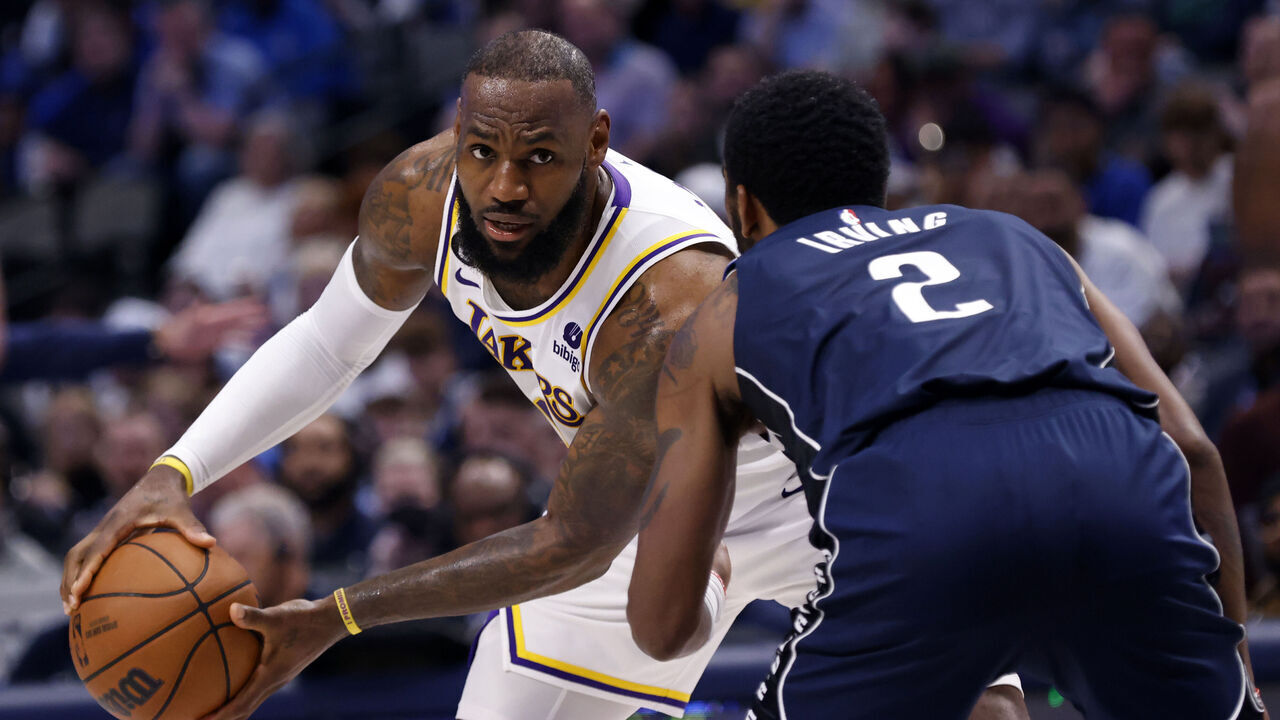 DALLAS, TX - FEBRUARY 26 : LeBron James #6 of the Los Angeles Lakers handles the ball against Kyrie Irving #2 of the Dallas Mavericks at American Airlines Center on February 26, 2023 in Dallas, Texas.