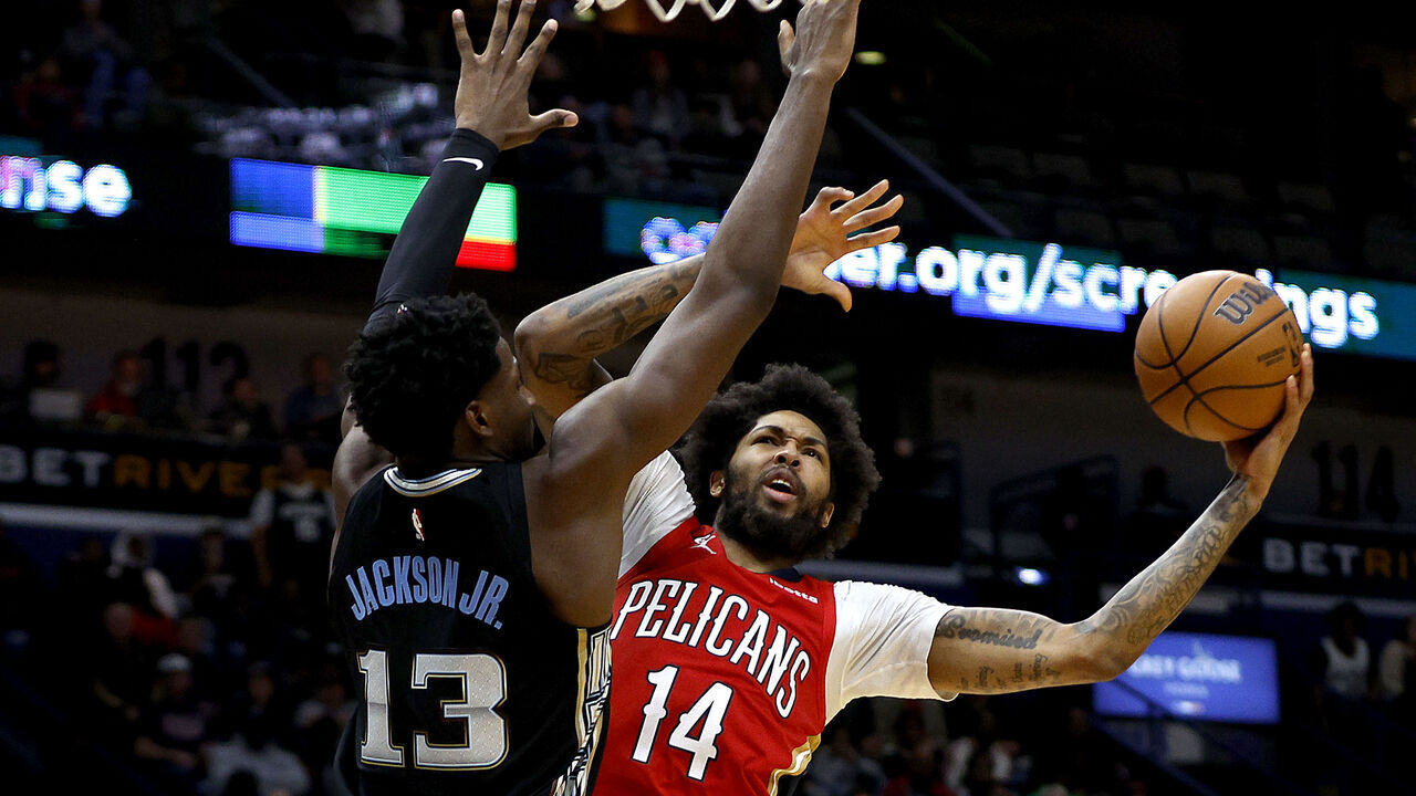 NEW ORLEANS, LOUISIANA - NOVEMBER 15: Brandon Ingram #14 of the New Orleans Pelicans shoots over Jaren Jackson Jr. #13 of the Memphis Grizzlies during the fourth quarter of an NBA game at Smoothie King Center on November 15, 2022 in New Orleans, Louisiana. New Orleans Pelicans won the game 113 - 102.