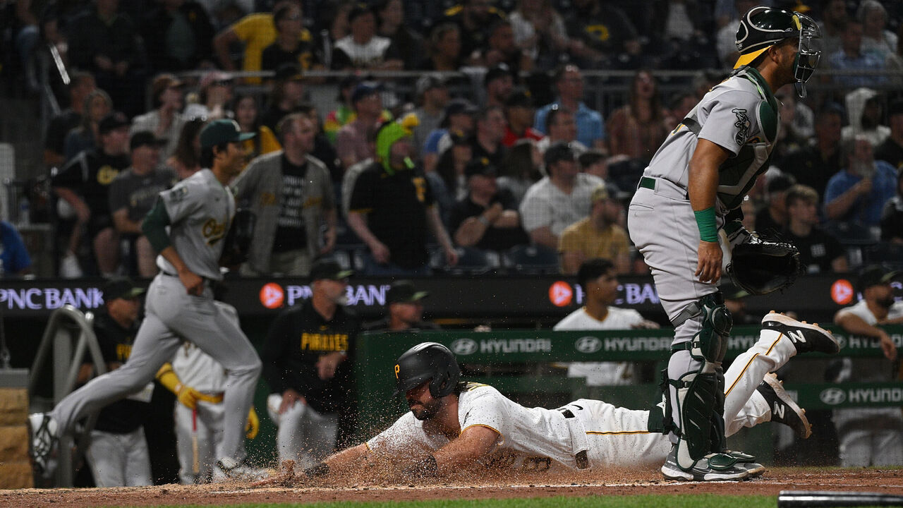 PITTSBURGH, PA - JUNE 5: Austin Hedges #18 of the Pittsburgh Pirates slides in safety at home past Carlos Perez #44 of the Oakland Athletics to score in the sixth inning at PNC Park on June 5, 2023 in Pittsburgh, Pennsylvania.
