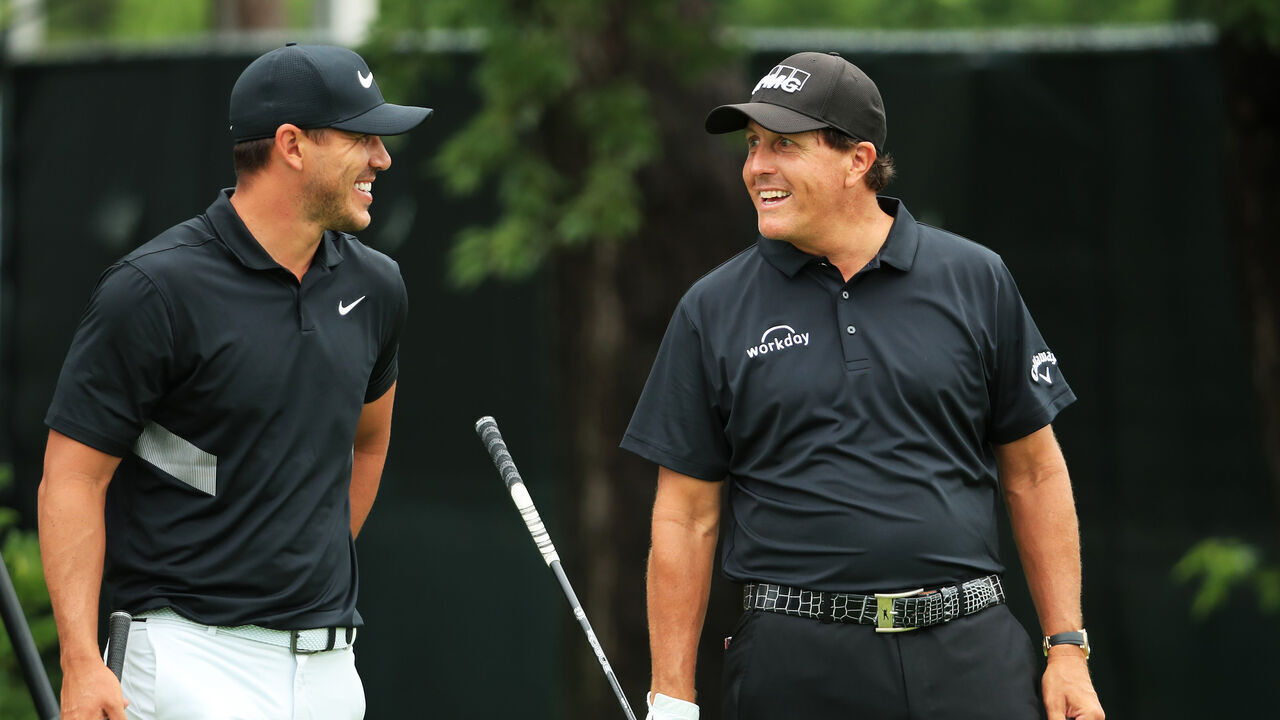 MEDINAH, ILLINOIS - AUGUST 18: Brooks Koepka of the United States and Phil Mickelson of the United States talk on the tenth tee during the final round of the BMW Championship at Medinah Country Club No. 3 on August 18, 2019 in Medinah, Illinois.
