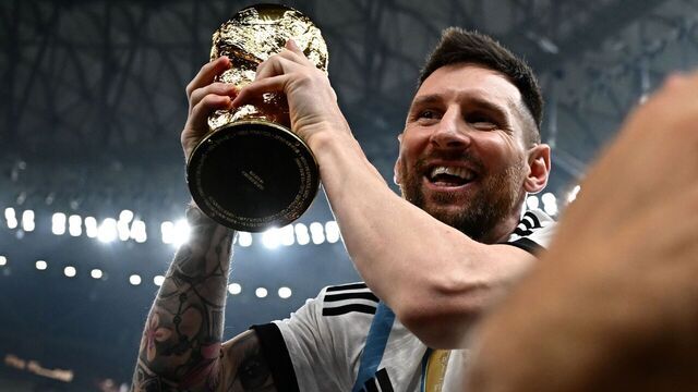 TOPSHOT - Argentina's captain and forward #10 Lionel Messi holds the FIFA World Cup Trophy following the trophy ceremony after Argentina won the Qatar 2022 World Cup final football match between Argentina and France at Lusail Stadium in Lusail, north of Doha on December 18, 2022.