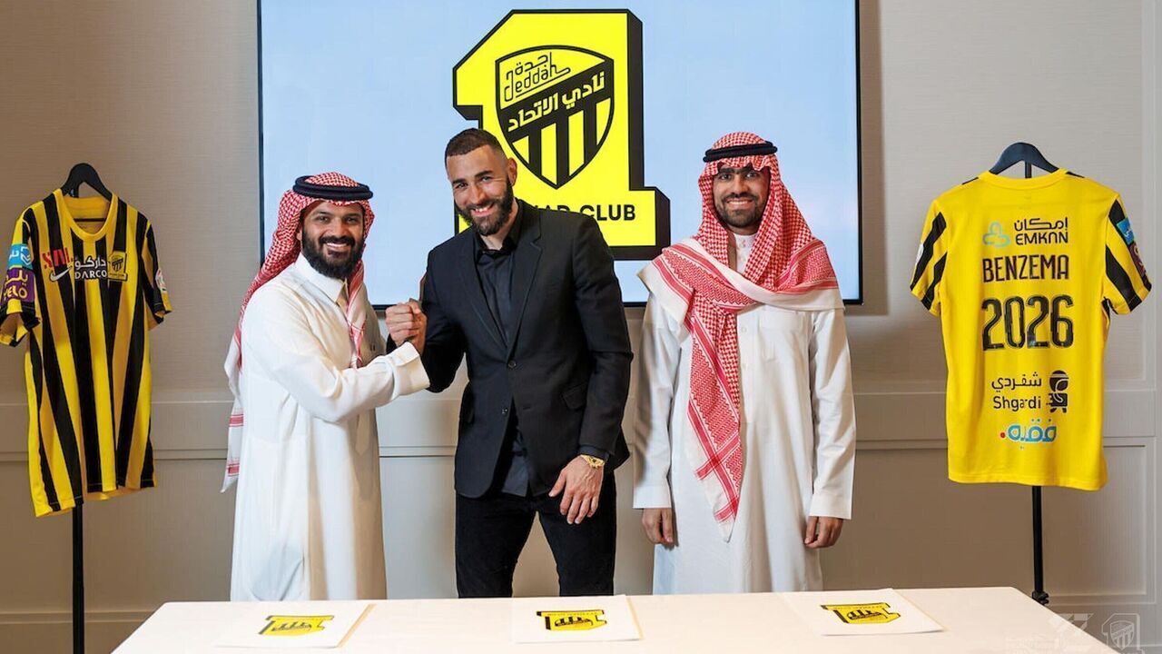 JEDDAH, SAUDI ARABIA - JUNE 06: (----EDITORIAL USE ONLY â" MANDATORY CREDIT - "AL ITTIHAD FOOTBALL CLUB / HANDOUT" - NO MARKETING NO ADVERTISING CAMPAIGNS - DISTRIBUTED AS A SERVICE TO CLIENTS----) 35 year-old French soccer star, Karim Benzema (C) holds a jersey of Al-Ittihad, a Saudi Arabian soccer team in Jeddah, Saudi Arabia on June 06, 2023. Benzema left Real Madrid and signed a 3 year contract with Al-Ittihad.