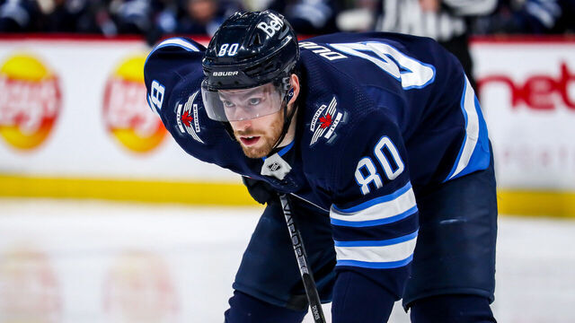 WINNIPEG, CANADA - APRIL 8: Pierre-Luc Dubois #80 of the Winnipeg Jets gets set during a second period face-off against the Nashville Predators at the Canada Life Centre on April 8, 2023 in Winnipeg, Manitoba, Canada.