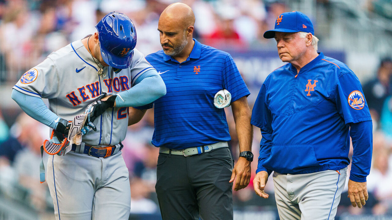 ATLANTA, GA - JUNE 7: Buck Showalter #11 of the New York Mets and a member of the Mets training staff examine Pete Alonso #20 after being hit by a pitch in the first inning during the game against the New York Mets at Truist Park on June 7, 2023 in Atlanta, Georgia.