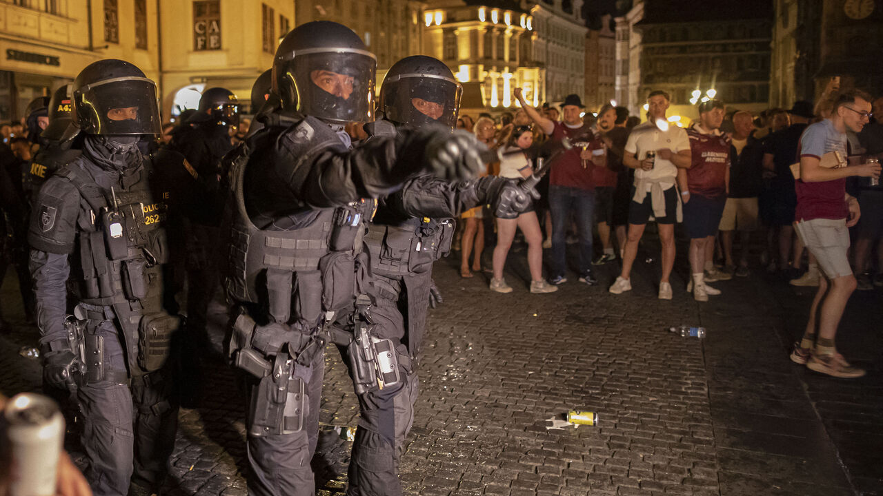 Czech riot police controls a crowd of West Ham United supporters celebrating at the Old Town Square after their team won the UEFA Europa Conference League 2022/23 final match between ACF Fiorentina and West Ham United FC in Prague, Czech Republic on June 7, 2023.