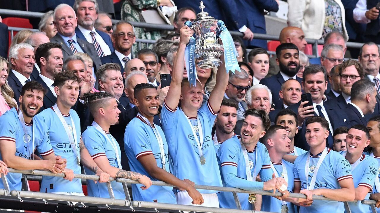 TOPSHOT - Manchester City's Norwegian striker Erling Haaland (C) lifts the trophy after the English FA Cup final football match between Manchester City and Manchester United at Wembley stadium, in London, on June 3, 2023. Man City won the game 2-1.