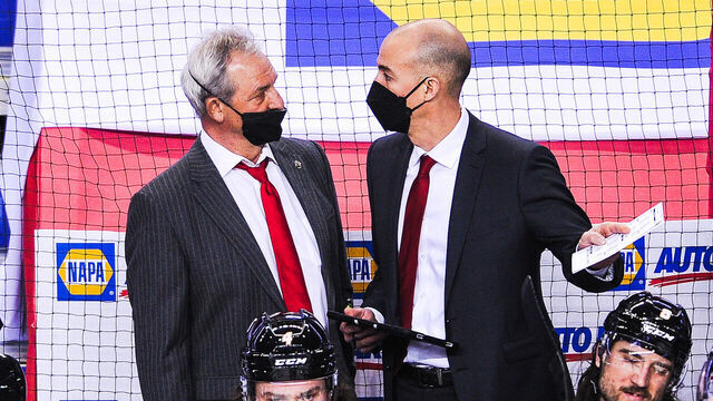 CALGARY, AB - MARCH 11: Head Coach Darryl Sutter and Assistant Coach Ryan Huska of the Calgary Flames confer during a break in play against the Montreal Canadiens during an NHL game at Scotiabank Saddledome on March 11, 2021 in Calgary, Alberta, Canada.