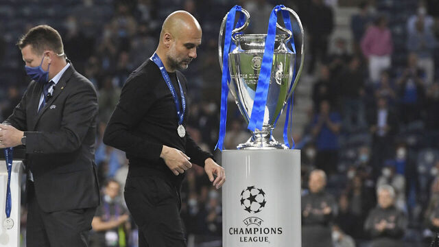 PORTO, PORTUGAL - MAY 29: Pep Guardiola, Manager of Manchester City looks dejected as he walks past the Champions League Trophy after the UEFA Champions League Final between Manchester City and Chelsea FC at Estadio do Dragao on May 29, 2021 in Porto, Portugal.