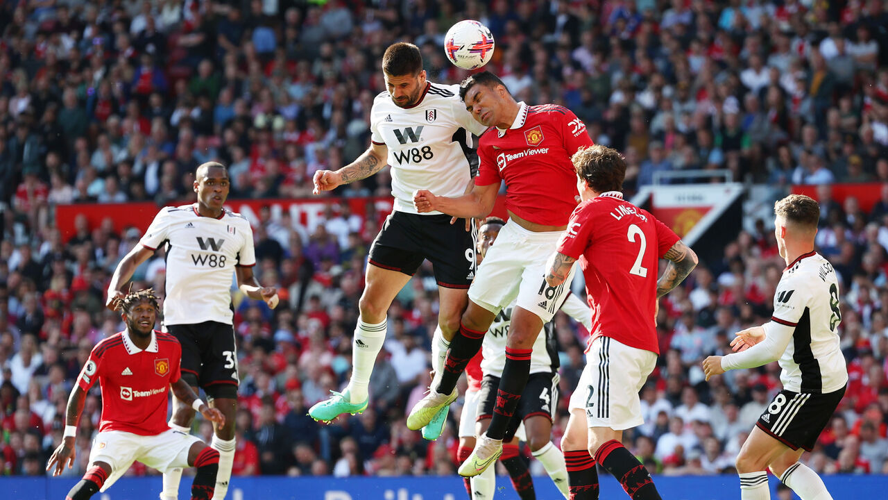 MANCHESTER, ENGLAND - MAY 28: Aleksandar Mitrovic of Fulham challenges for a header with Casemiro of Manchester United during the Premier League match between Manchester United and Fulham FC at Old Trafford on May 28, 2023 in Manchester, England.