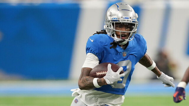 DETROIT, MICHIGAN - JANUARY 01: Jameson Williams #9 of the Detroit Lions runs the ball after a catch while chased by Joe Thomas #45 of the Chicago Bears during the third quarter at Ford Field on January 01, 2023 in Detroit, Michigan.