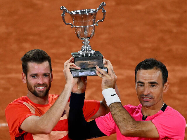 PARIS, FRANCE - JUNE 10: Ivan Dodig of Croatia and partner Austin Krajicek of United States pose with the winners trophy after victory against Sander Gille of Belgium and Joran Vliegen of Belgium during the Men's Doubles Final match on Day Fourteen of the 2023 French Open at Roland Garros on June 10, 2023 in Paris, France.