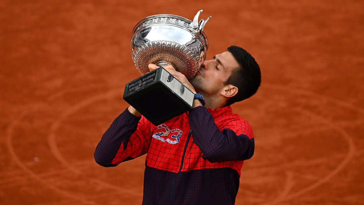 PARIS, FRANCE - JUNE 11: Novak Djokovic of Serbia kisses the winners trophy after victory against Casper Ruud of Norway in the Men's Singles Final match on Day Fifteen of the 2023 French Open at Roland Garros on June 11, 2023 in Paris, France.
