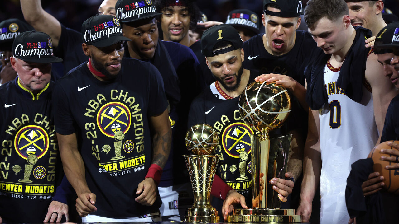 DENVER, COLORADO - JUNE 12: The Denver Nuggets celebrate with the Larry O'Brien Championship Trophy after a 94-89 victory against the Miami Heat in Game Five of the 2023 NBA Finals to win the NBA Championship at Ball Arena on June 12, 2023 in Denver, Colorado.