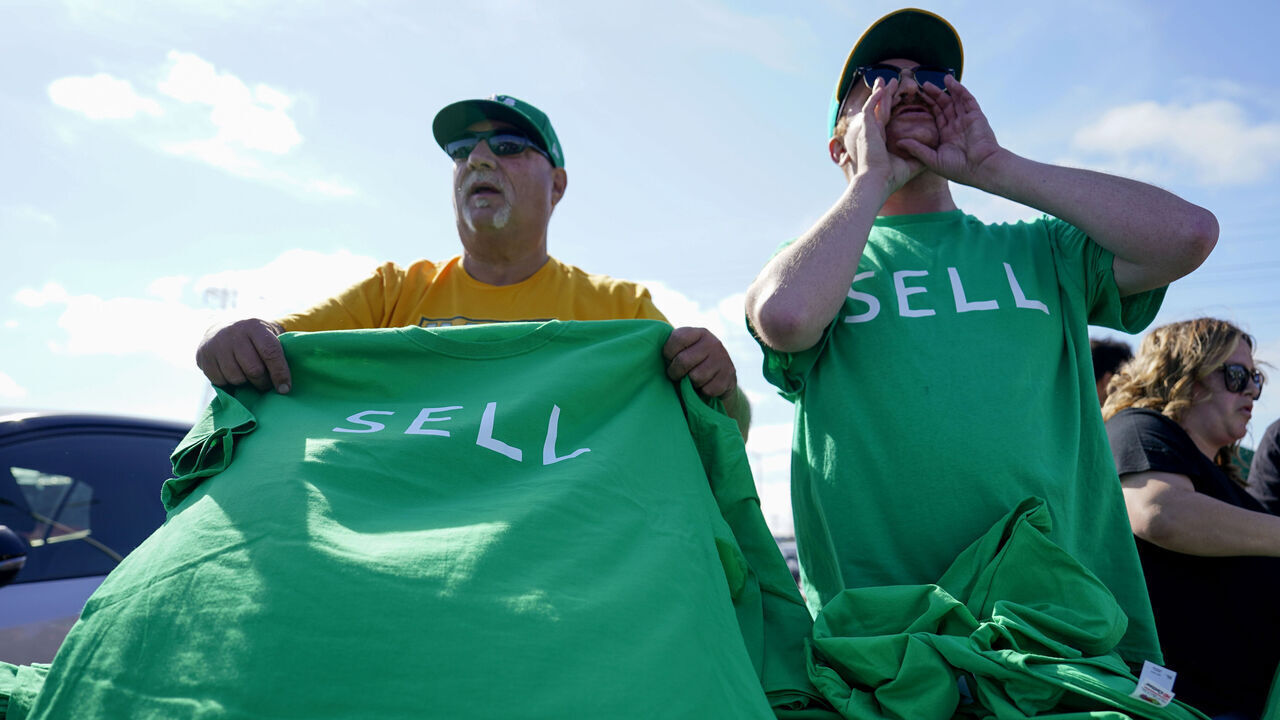 OAKLAND, CALIFORNIA - JUNE 13: Oakland Athletics fans are handed out free t-shirt shirts labeled 'SELL' prior to a reverse boycott game against the Tampa Bay Rays at RingCentral Coliseum on June 13, 2023 in Oakland, California.
