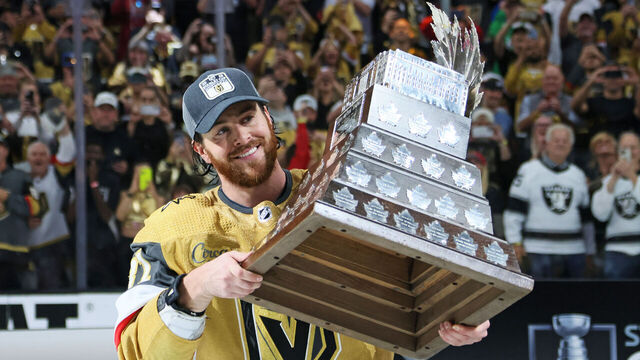 LAS VEGAS, NEVADA - JUNE 13: Jonathan Marchessault #81 of the Vegas Golden Knights hoists the Con Smyth Trophy after a championship win against the Florida Panthers in Game Five of the 2023 NHL Stanley Cup Final at T-Mobile Arena on June 13, 2023 in Las Vegas, Nevada.