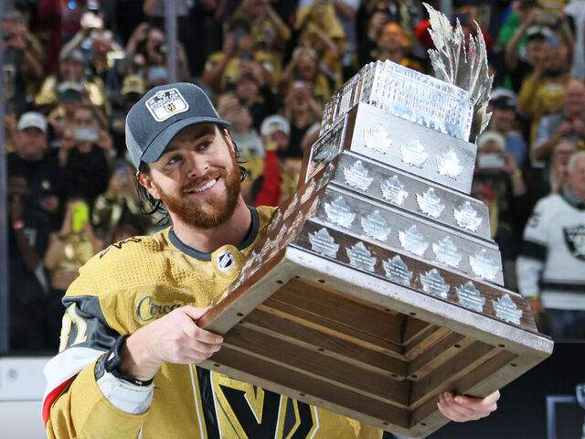 LAS VEGAS, NEVADA - JUNE 13: Jonathan Marchessault #81 of the Vegas Golden Knights hoists the Con Smyth Trophy after a championship win against the Florida Panthers in Game Five of the 2023 NHL Stanley Cup Final at T-Mobile Arena on June 13, 2023 in Las Vegas, Nevada.