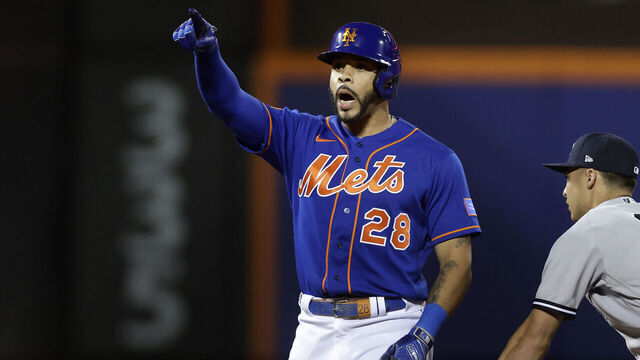 NEW YORK, NEW YORK - JUNE 14: Tommy Pham #28 of the New York Mets celebrates his fifth inning RBI double next to Anthony Volpe #11 of the New York Yankees at Citi Field on June 14, 2023 in New York City.