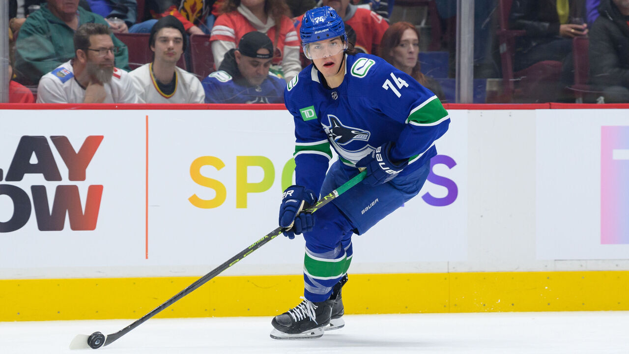 VANCOUVER, CANADA - MARCH 31: Ethan Bear #74 of the Vancouver Canucks skates with the puck during the second period of their NHL game against the Calgary Flames at Rogers Arena on March 31, 2023 in Vancouver, British Columbia, Canada.