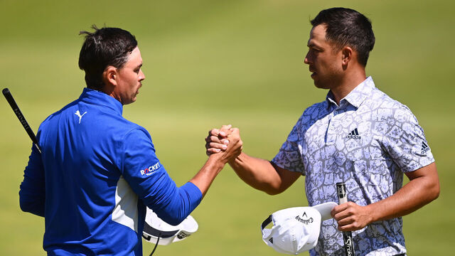 SANDWICH, ENGLAND - JULY 16: Rickie Fowler of The United States and Xander Schauffele of The United States interact on the 18th green after their rounds during Day Two of The 149th Open at Royal St George’s Golf Club on July 16, 2021 in Sandwich, England.