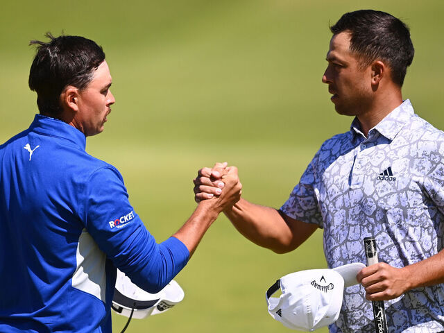 SANDWICH, ENGLAND - JULY 16: Rickie Fowler of The United States and Xander Schauffele of The United States interact on the 18th green after their rounds during Day Two of The 149th Open at Royal St George’s Golf Club on July 16, 2021 in Sandwich, England.
